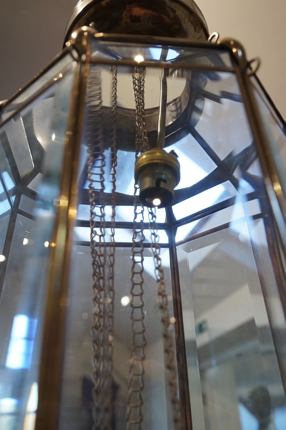 A Moroccan hanging brass and eight panelled glass lantern, 60cm long. Condition - good